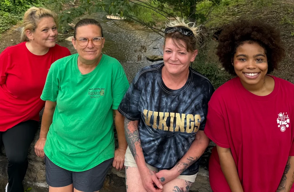 Four women together during a nature walk.